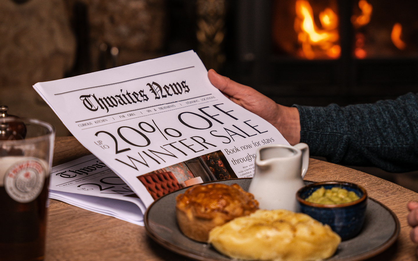 "up to 20% off this winter" newspaper with a pie and a pint at a pub table